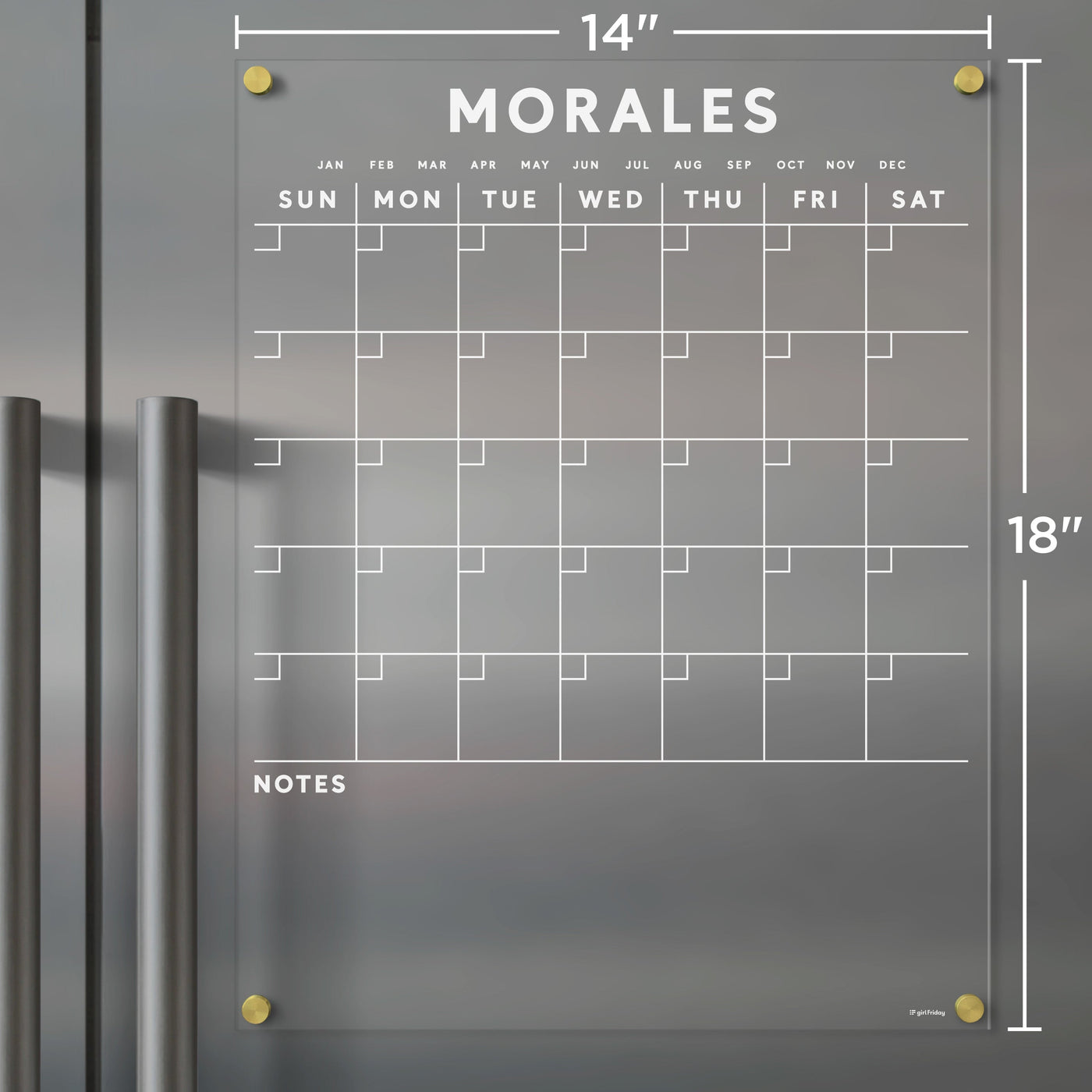 The Acrylic Fridge Calendar by Girl Friday features a clear, 14x18 inch surface with a Sunday-Saturday grid layout and custom family name MORALES in bold at the top. The months are listed above and it includes a bottom NOTES section, ideal for use with wet-erase markers.