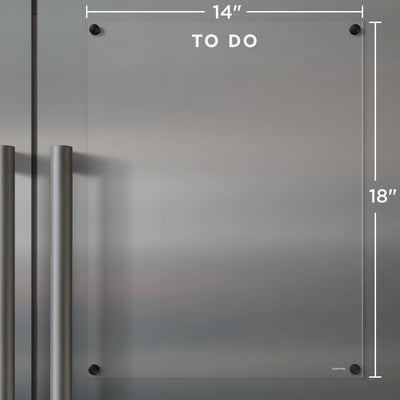 The Clear Acrylic Fridge To Do List by Girl Friday offers customization with white text. This 14x18 board rests on stainless steel, features a TO DO label at the top, and attaches with four black fasteners. Ideal for notes with wet-erase markers.
