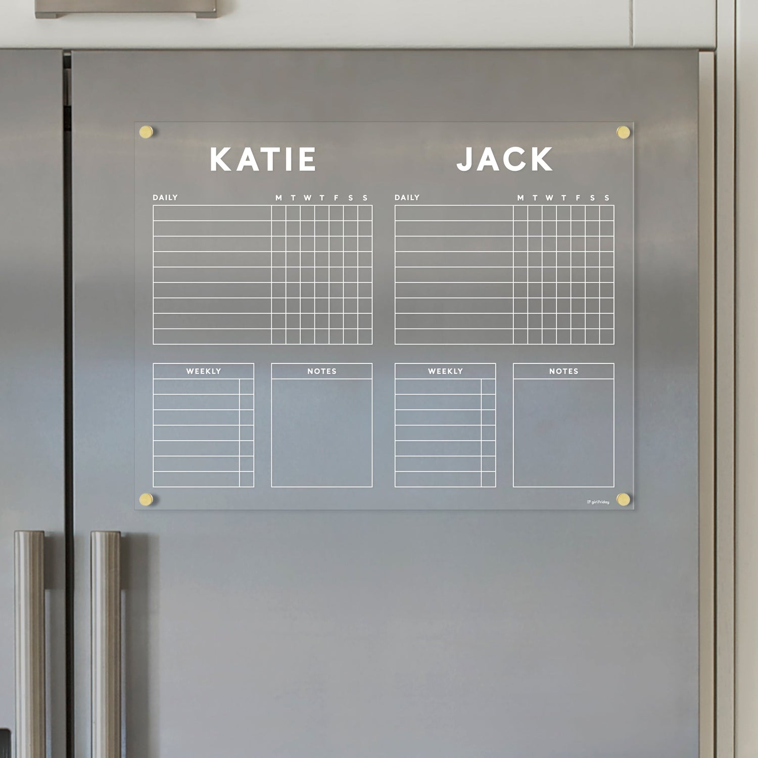 The Girl Friday Acrylic Fridge Chore Chart for 2 children features magnetic planners labeled Katie and Jack, with daily/weekly grids, ample note space, and wet-erase markers for easy updates on a stainless steel refrigerator.