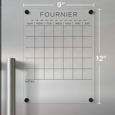 The FOURNIER wall calendar by Girl Friday, crafted from clear acrylic, measures 9x12 inches. Ideal for wet-erase markers, it features a weekday grid and note space at the bottom, offering a sleek solution for organizing your schedule.