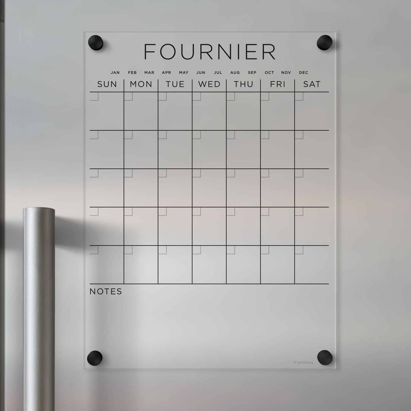 The Clear Acrylic Monthly Magnetic Fridge Calendar | Custom Family Name by Girl Friday is a transparent, customizable calendar with labeled months and days. It has sections for daily plans, a Notes area, and mounts to metallic surfaces, ideal for wet-erase markers.