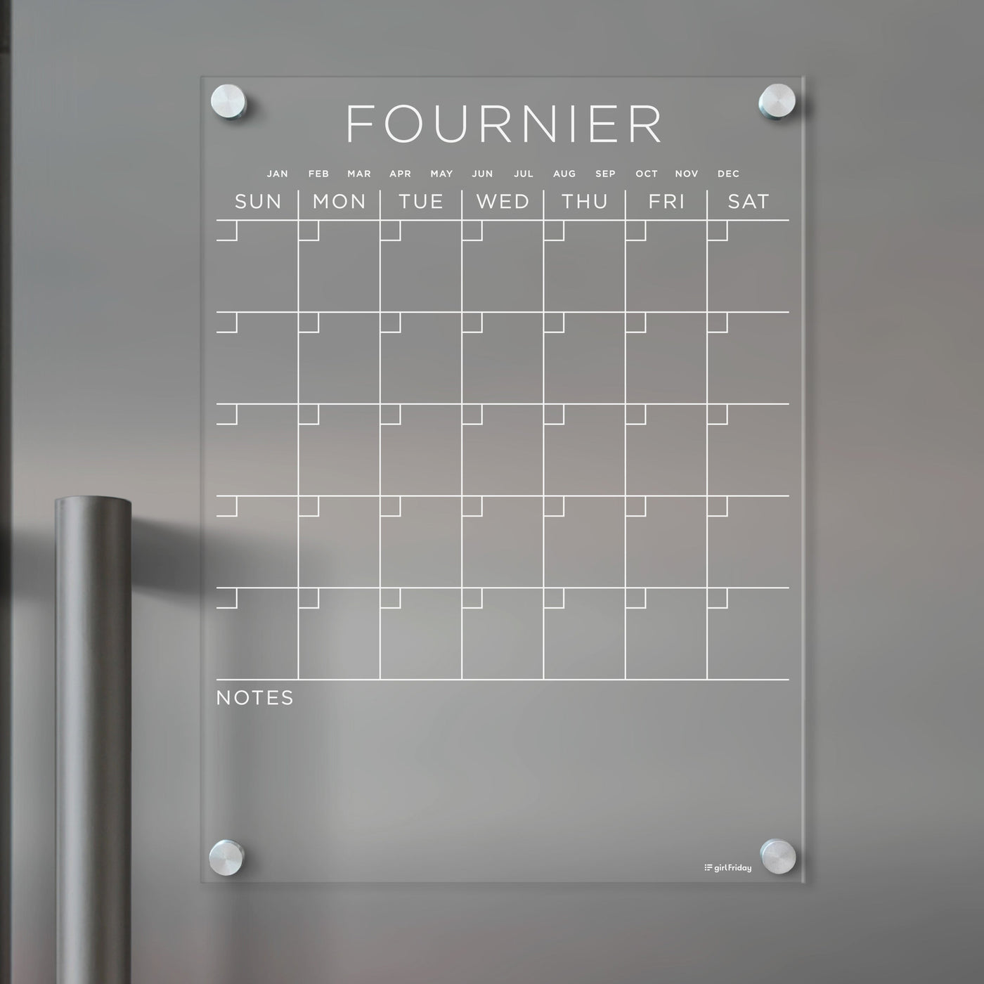 The Girl Friday Acrylic Fridge Calendar, customizable with your family name, features a weekly grid and note sections for wet-erase markers. Mounted with four silver pegs, its designed to keep your family stylishly organized.
