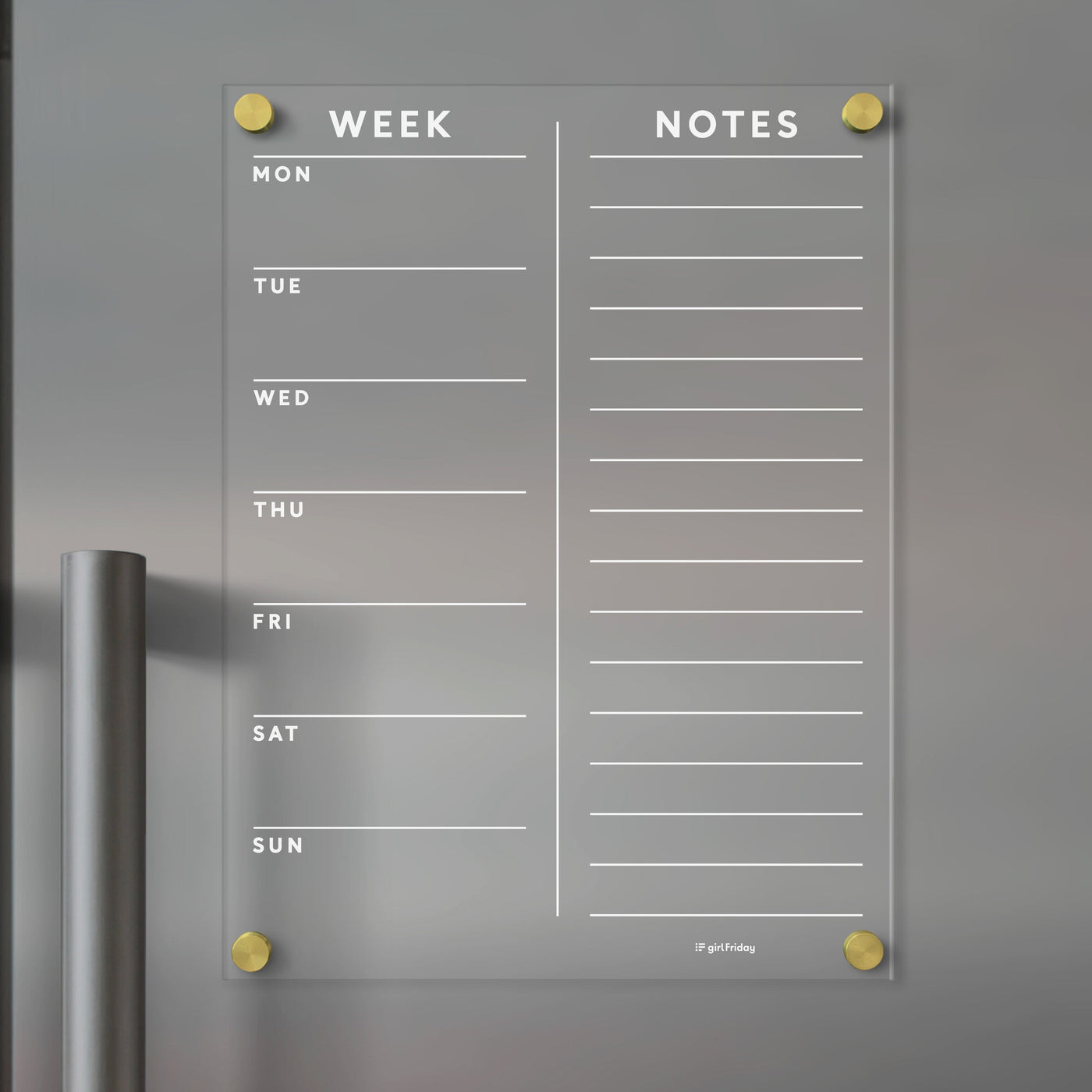The Clear Acrylic Customizable Fridge Calendar by Girl Friday features Week columns from Monday to Sunday and a Notes section. Use wet-erase markers on its wall-mounted design with gold corners, adapting it seamlessly as a dynamic planner board.