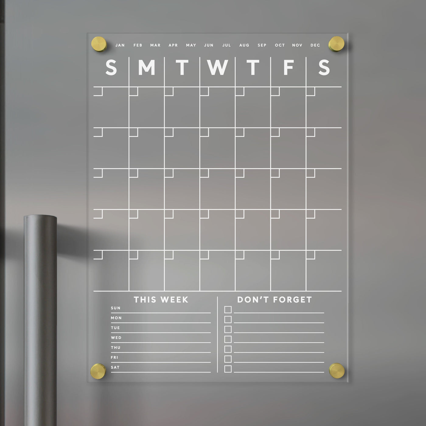 The Girl Friday Shop offers a Clear Acrylic Monthly Fridge Calendar that easily attaches to metallic surfaces. It features customizable bottom sections, is designed for use with wet-erase markers, and provides a sleek, transparent design perfect for quick updates.
