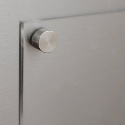 A close-up of a brushed metal door or cabinet with a cylindrical knob, showing sleek, modern lines and a reflective texture reminiscent of the precise physiological shifts on your Girl Friday Balanced Beyars Weekly Phase Board.
