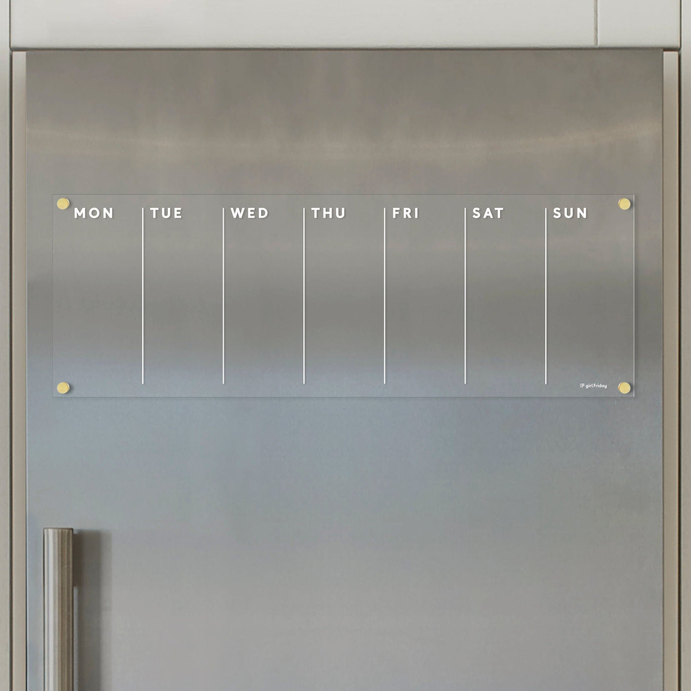 The Girl Friday Acrylic Fridge Calendar weekly is a modern and minimalist clear acrylic calendar with a magnetic surface, featuring columns labeled MON-SUN. Its perfect for wet-erase markers and fits stylishly on your stainless steel fridge.